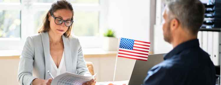 A USCIS officer interviewing a US citizen for naturalization